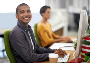 Proud of his work ethic. A young designer working in the office.